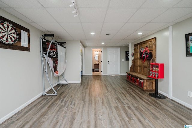 interior space featuring wood-type flooring and a paneled ceiling