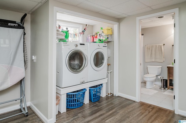 clothes washing area featuring independent washer and dryer and hardwood / wood-style flooring