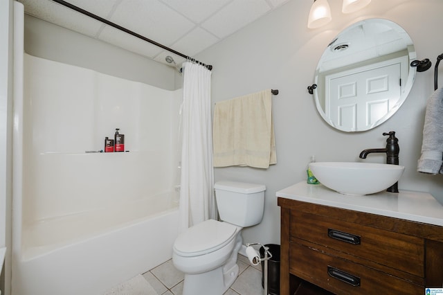 full bathroom featuring shower / bath combo, a paneled ceiling, vanity, tile patterned flooring, and toilet