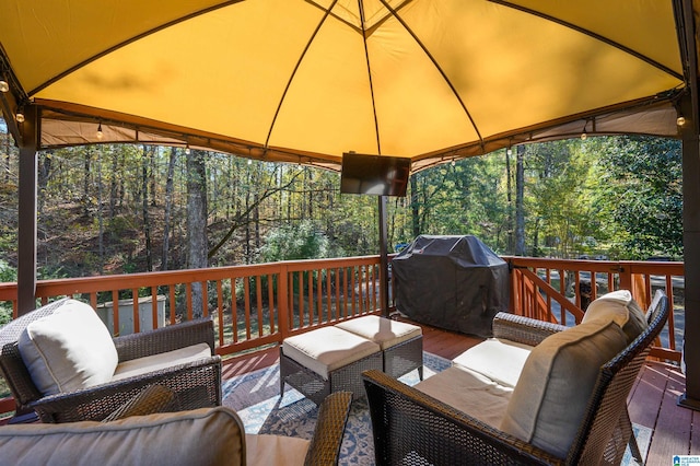 wooden terrace featuring a grill