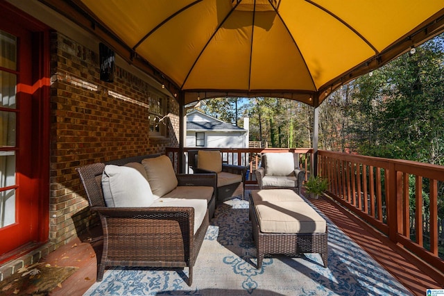 wooden deck with a gazebo and outdoor lounge area