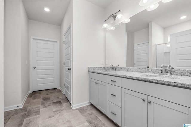 bathroom featuring vanity and a shower with door