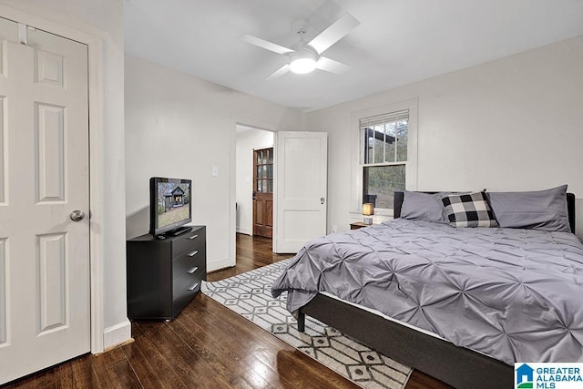 bedroom with ceiling fan and dark wood-type flooring