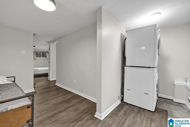 interior space featuring dark hardwood / wood-style flooring and stacked washer and dryer