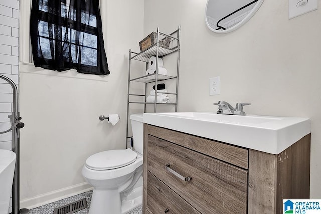 bathroom featuring tile patterned floors, vanity, and toilet