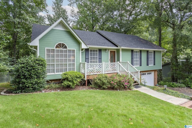 view of front facade with a porch, a front yard, and a garage