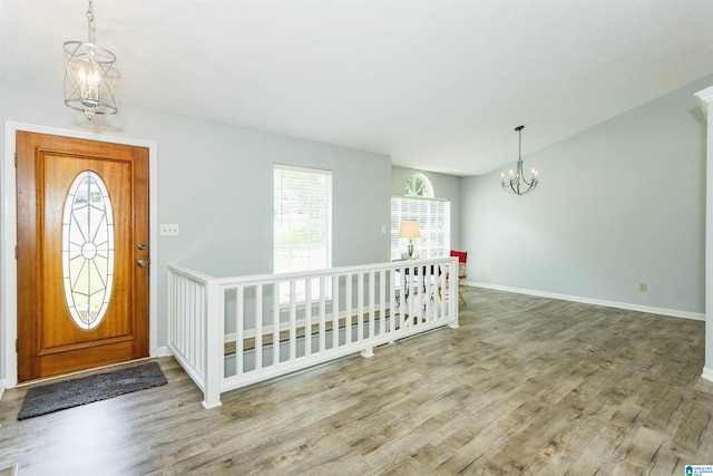 entryway featuring wood-type flooring and an inviting chandelier