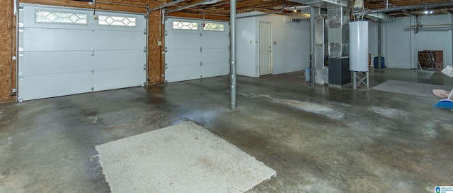 garage featuring heating unit and water heater