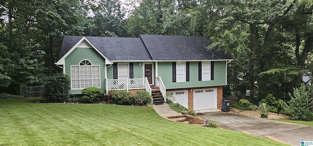 view of front of property featuring covered porch, a garage, and a front lawn