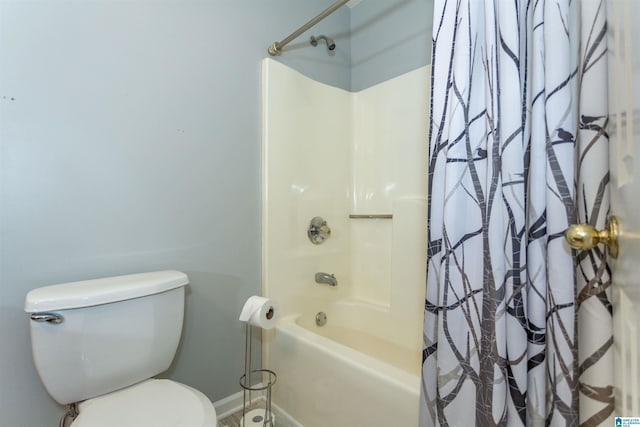 bathroom featuring toilet and shower / bathtub combination with curtain