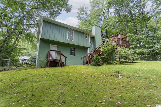 rear view of property with a yard