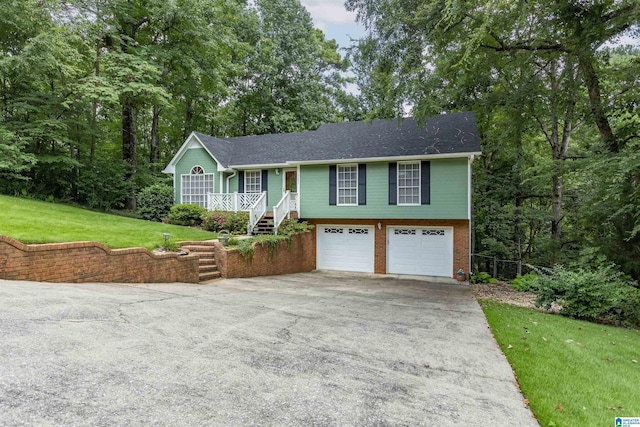 view of front of property with a porch, a garage, and a front lawn