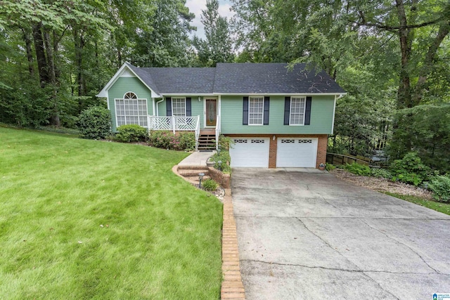 view of front of house featuring covered porch, a garage, and a front lawn