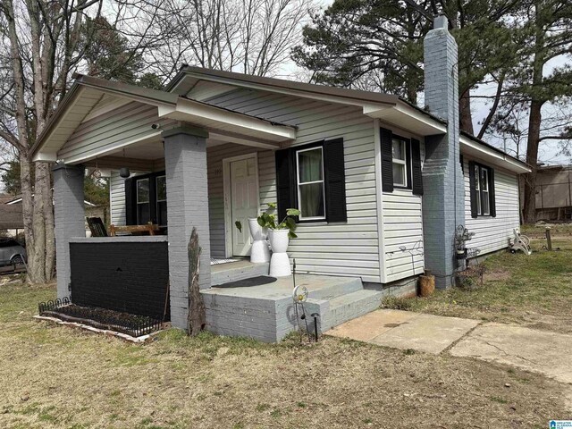 bungalow-style home with a chimney