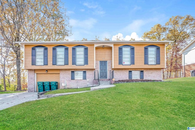 bi-level home featuring a garage and a front yard