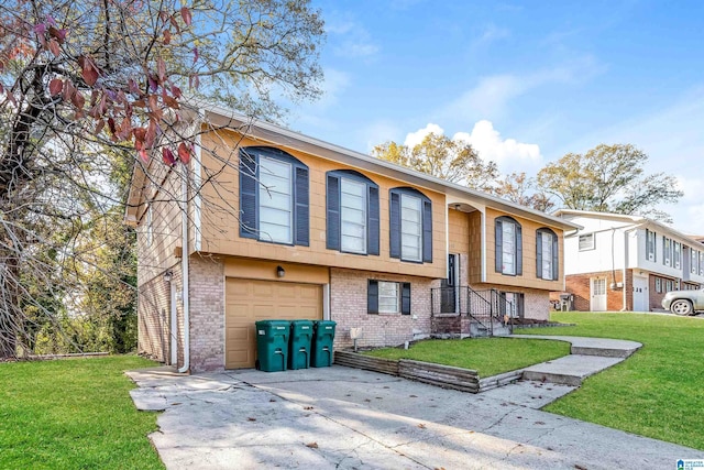 raised ranch with a garage and a front yard