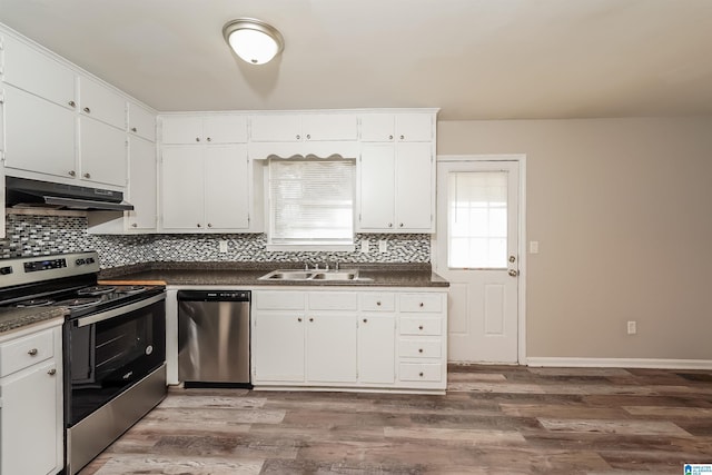 kitchen featuring white cabinets, sink, stainless steel appliances, and hardwood / wood-style floors