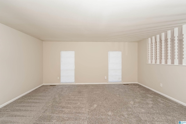 carpeted empty room featuring a wealth of natural light