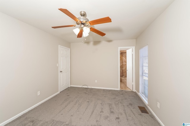 spare room with light carpet and ceiling fan