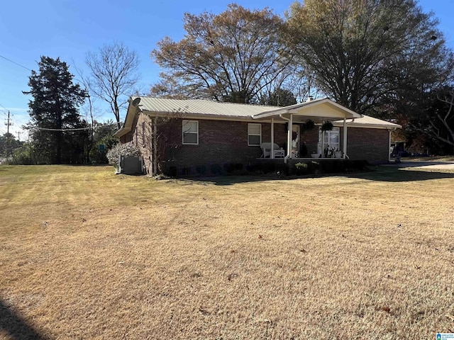 single story home featuring covered porch and a front yard