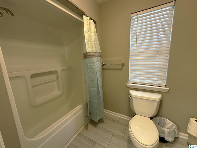 bathroom with shower / tub combo and toilet