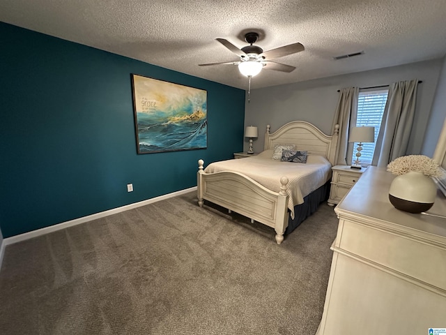 carpeted bedroom featuring ceiling fan and a textured ceiling