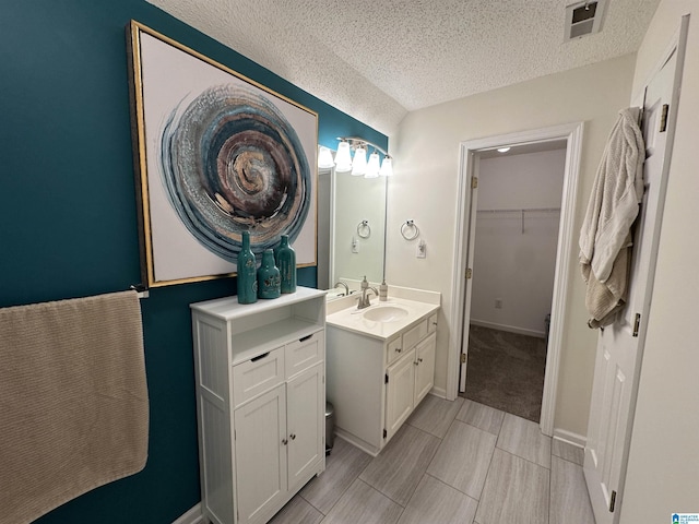 bathroom with vanity and a textured ceiling