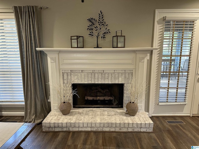 details featuring hardwood / wood-style floors and a brick fireplace