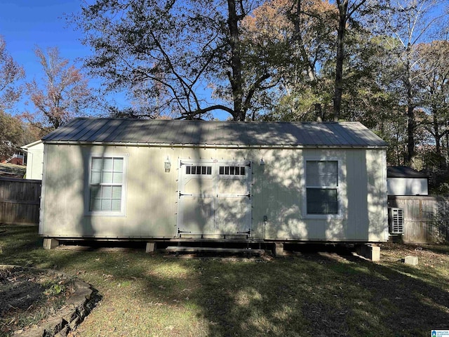 back of house featuring an outbuilding and a yard