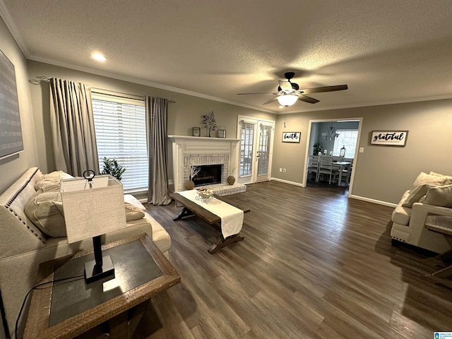 living room with a textured ceiling, ceiling fan, plenty of natural light, and dark hardwood / wood-style floors