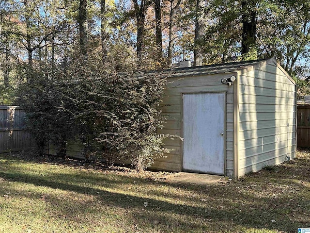 view of outdoor structure featuring a lawn