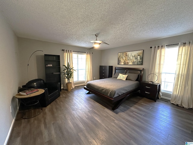 bedroom featuring a textured ceiling, ceiling fan, and dark wood-type flooring