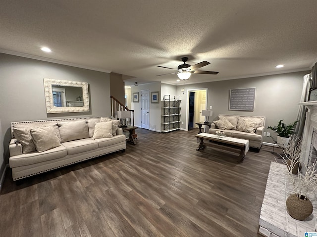 living room with a textured ceiling, dark hardwood / wood-style floors, ceiling fan, and crown molding