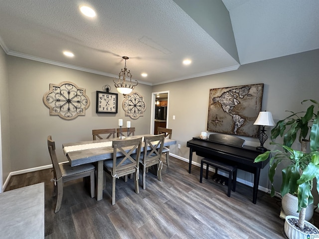 dining area with a textured ceiling, dark hardwood / wood-style floors, and ornamental molding