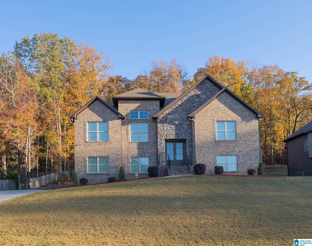 view of front of property featuring french doors and a front lawn