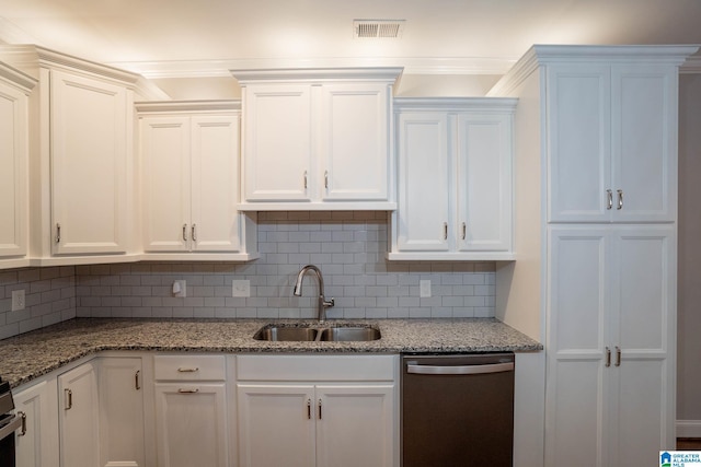 kitchen with light stone countertops, sink, stainless steel dishwasher, backsplash, and white cabinets