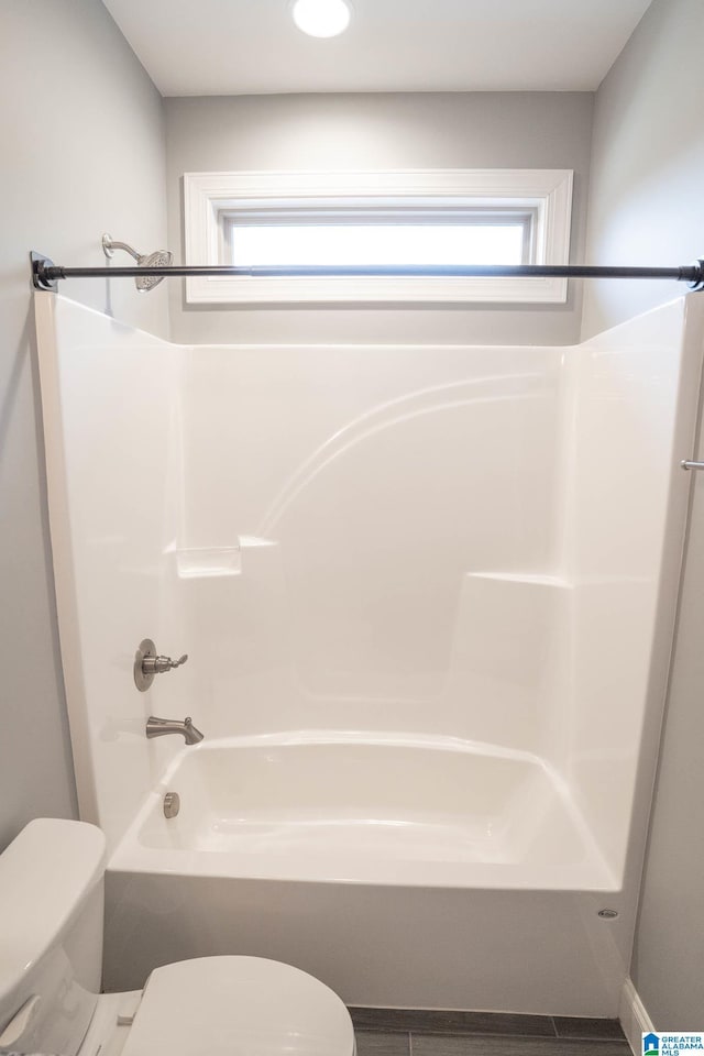 bathroom with toilet and shower / tub combination