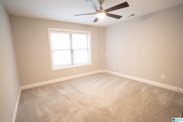 spare room featuring ceiling fan and carpet floors