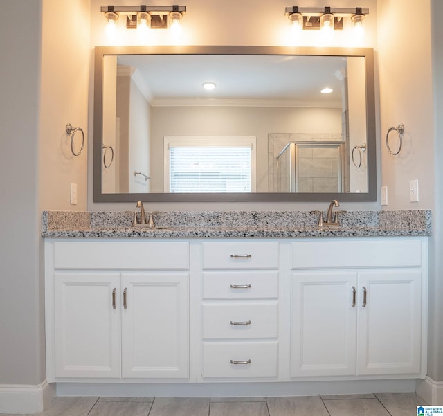 bathroom featuring vanity, tile patterned floors, an enclosed shower, and crown molding