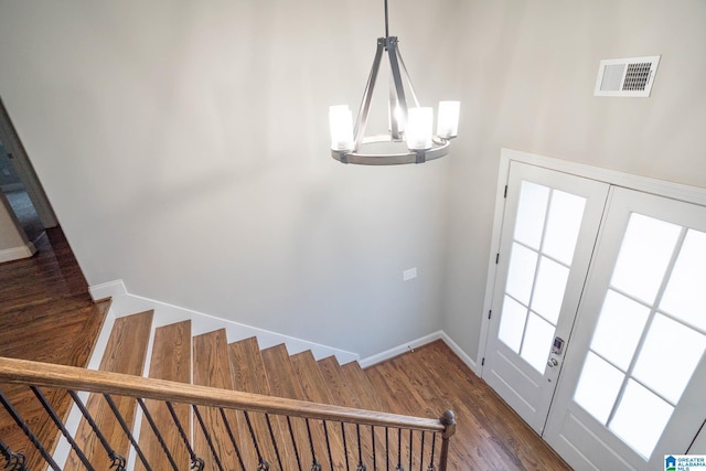 interior space featuring dark wood-type flooring and an inviting chandelier