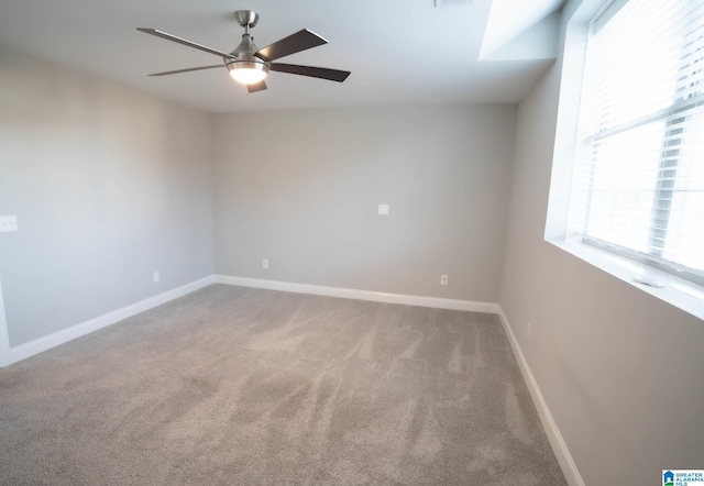 spare room featuring ceiling fan and carpet floors