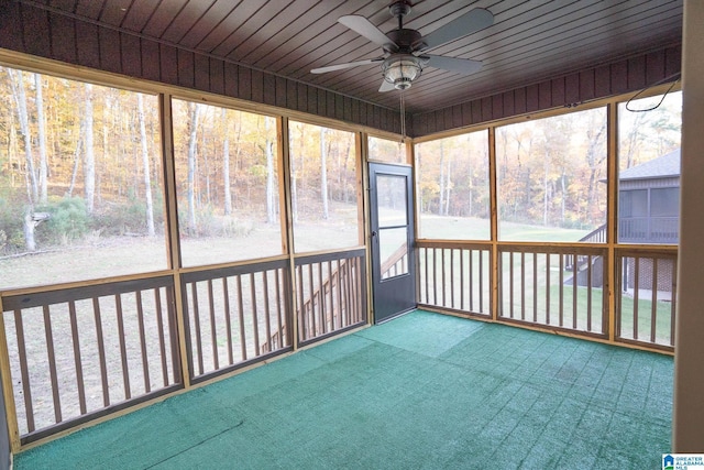 unfurnished sunroom with ceiling fan and wooden ceiling