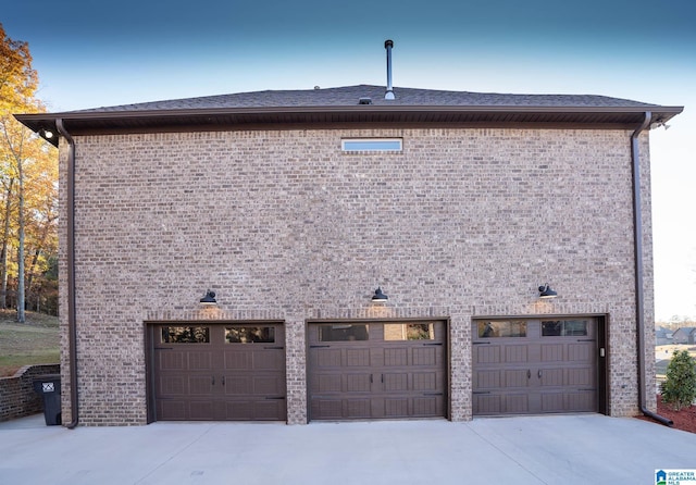 view of side of property with a garage