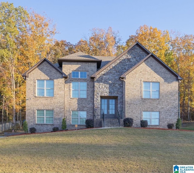 view of front of house featuring a front yard and french doors