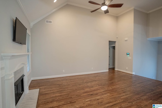 unfurnished living room with crown molding, vaulted ceiling, ceiling fan, a fireplace, and wood-type flooring