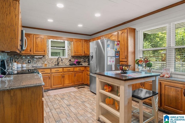 kitchen featuring crown molding, sink, decorative backsplash, and stainless steel appliances