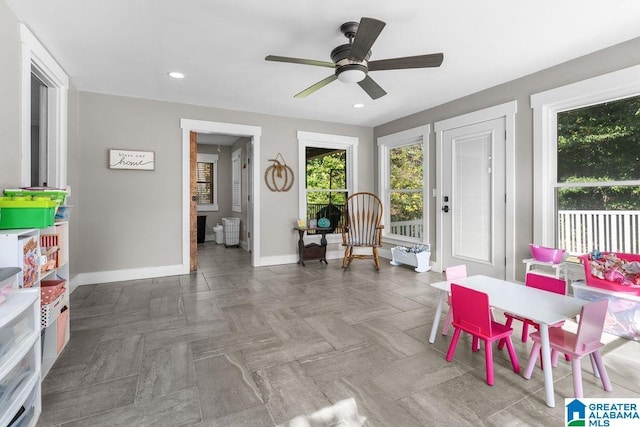 interior space with ceiling fan