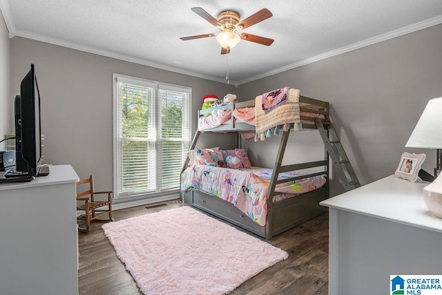 bedroom featuring ceiling fan, dark hardwood / wood-style flooring, a textured ceiling, and ornamental molding