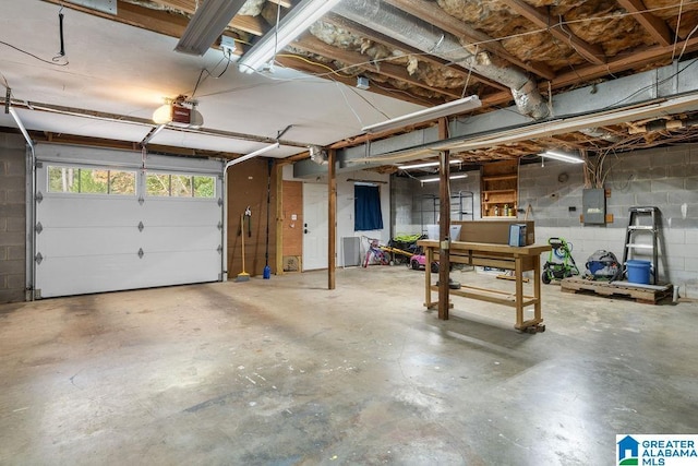 garage featuring electric panel and a garage door opener