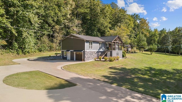 view of front of house with a front lawn and a sunroom